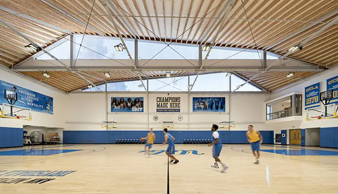 Team members playing in the solar controlled, light filled gymnasium.
