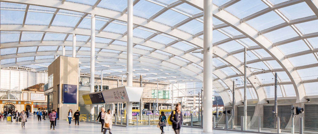 people walking under the Texlon ETFE roof at Manchester Victoria Station - a refurbishment project