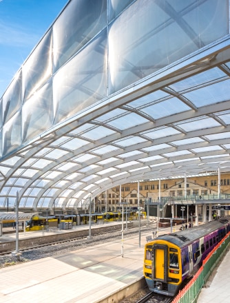 Train arrives under the Texlon ETFE roof at Manchester Victoria Station