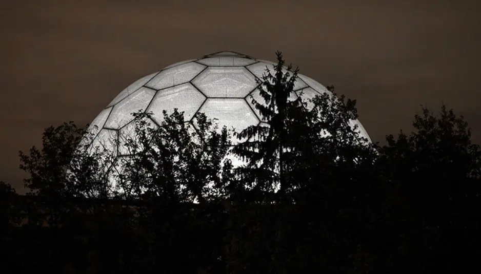Night time view of the illuminated ETFE geodesic dome.