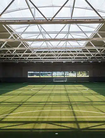 The transparent ETFE cushions let UV light shine on the indoor pitch.