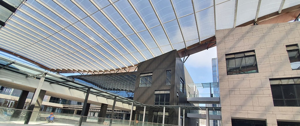 The Texlon® ETFE canopies are installed at a high level above the retail development.